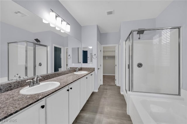 full bath featuring a shower stall, a sink, and visible vents
