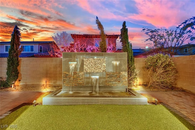 rear view of house with a fenced backyard