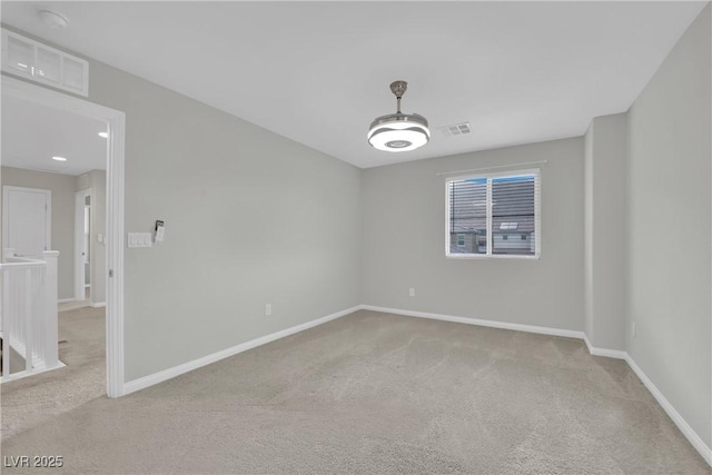 unfurnished room with light colored carpet, baseboards, and visible vents