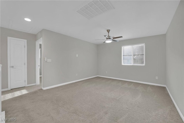 empty room with baseboards, a ceiling fan, visible vents, and carpet