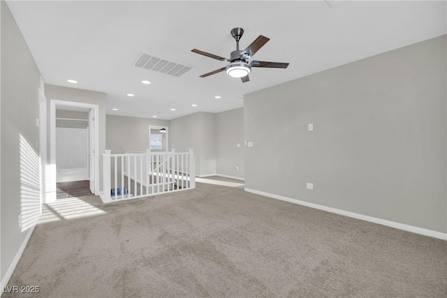 carpeted empty room with visible vents, recessed lighting, baseboards, and a ceiling fan