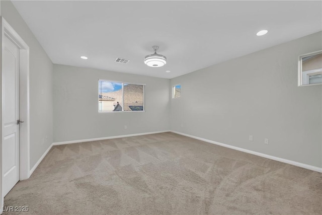 carpeted empty room featuring visible vents, recessed lighting, and baseboards