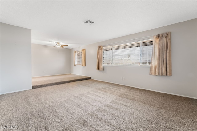 carpeted spare room featuring ceiling fan