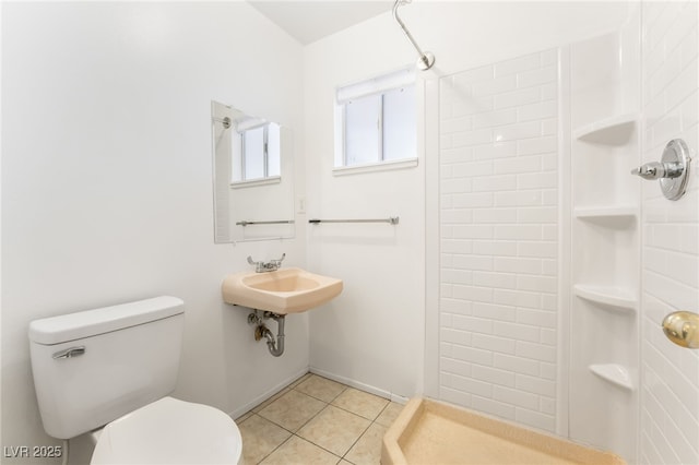 bathroom with tile patterned flooring, sink, toilet, and walk in shower