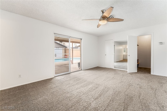 carpeted spare room with ceiling fan and a textured ceiling