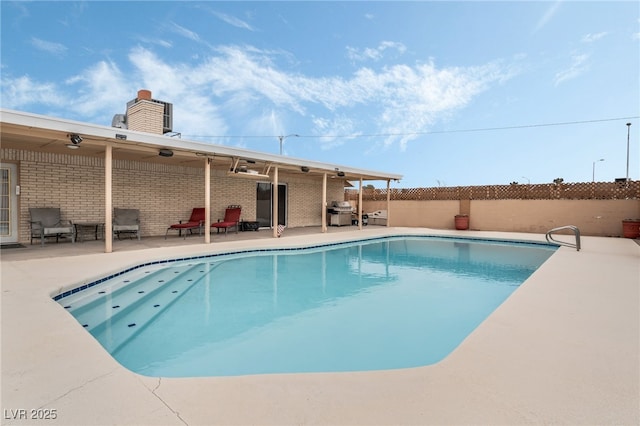 view of pool with ceiling fan and a patio area