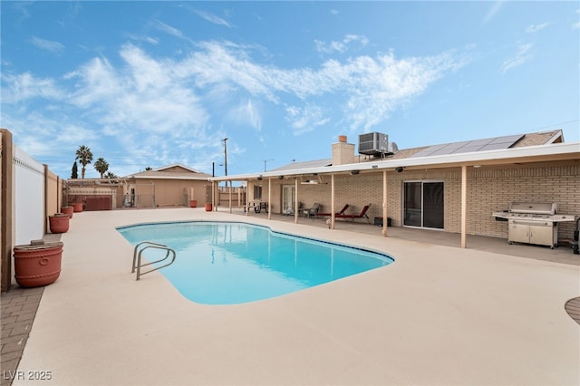 view of pool featuring cooling unit, a grill, and a patio