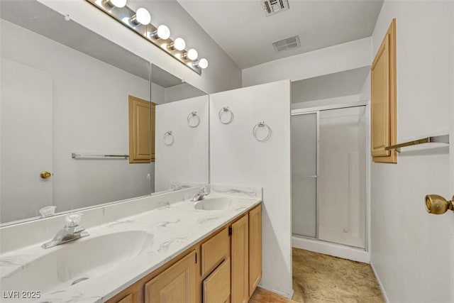 bathroom with vanity and a shower with door