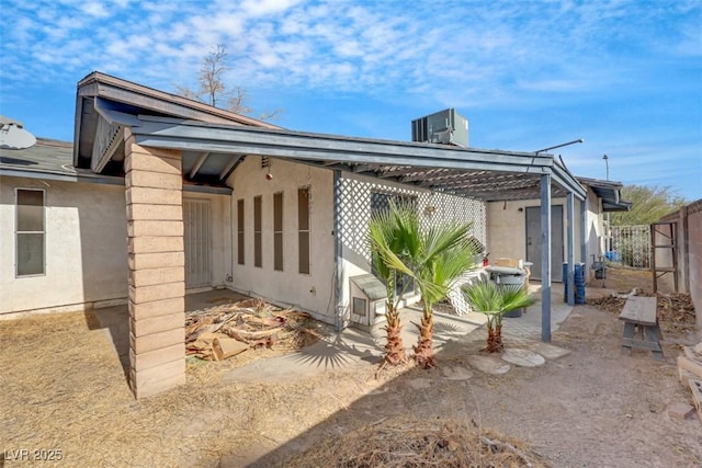 back of house featuring central air condition unit