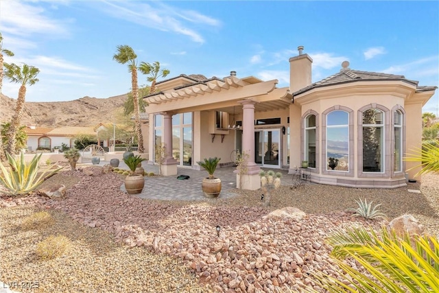 back of house with a mountain view