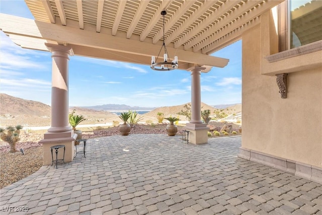 view of patio featuring a mountain view and a pergola