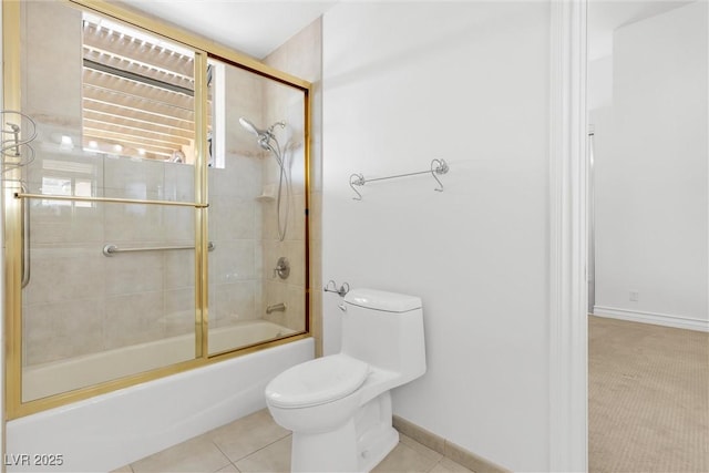 bathroom featuring tile patterned flooring, enclosed tub / shower combo, and toilet