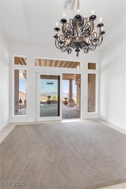 unfurnished living room featuring light colored carpet and a towering ceiling