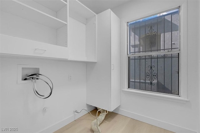 clothes washing area with baseboards, wood finished floors, laundry area, and hookup for a washing machine