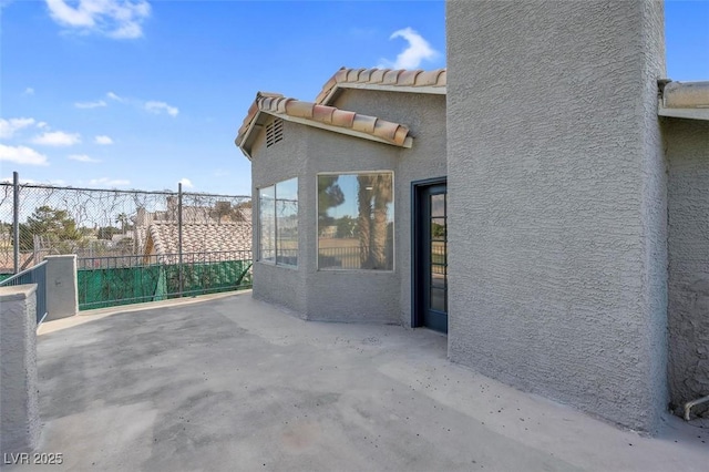 view of patio featuring fence