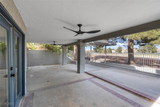 view of patio with ceiling fan and fence