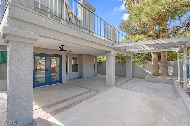 view of patio featuring fence, a ceiling fan, french doors, and a balcony
