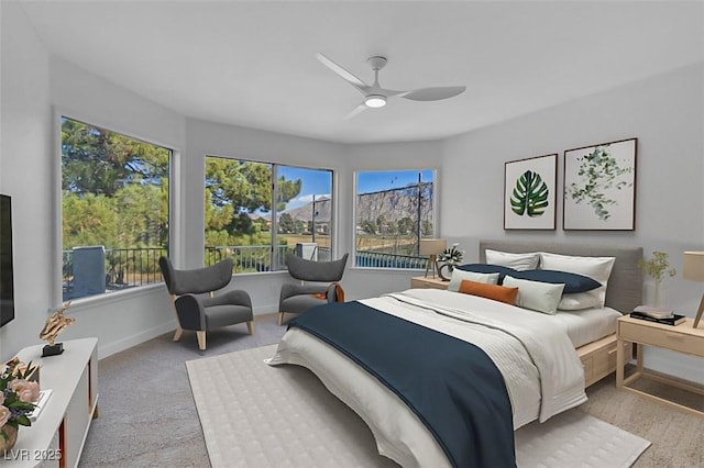 carpeted bedroom with multiple windows and ceiling fan