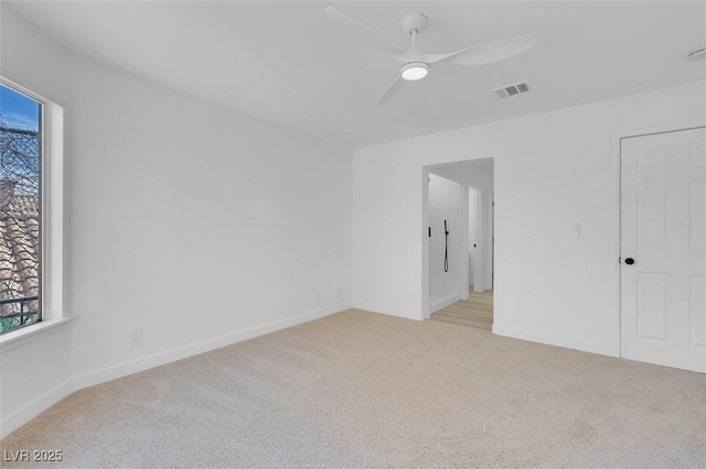 carpeted empty room featuring ceiling fan