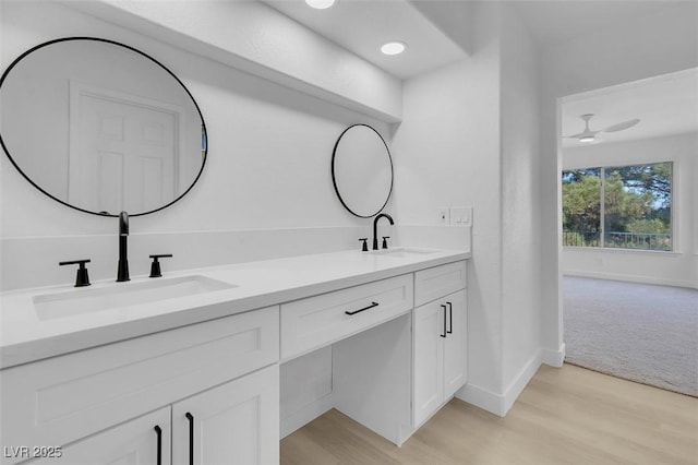 bathroom featuring vanity, hardwood / wood-style floors, and ceiling fan