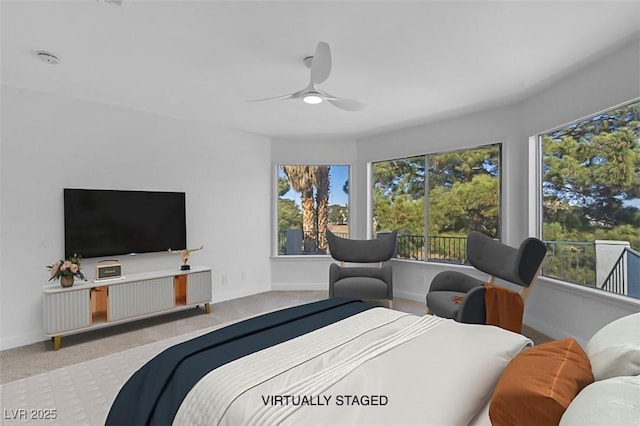 carpeted bedroom with baseboards and ceiling fan