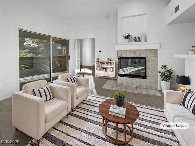 living room with a tiled fireplace