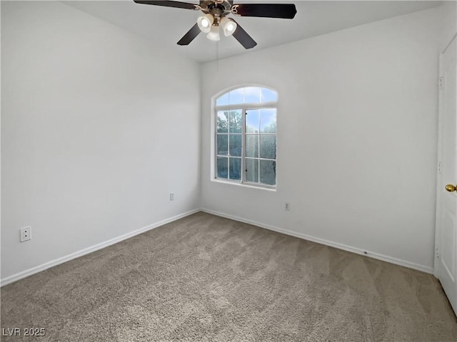 carpeted spare room featuring ceiling fan