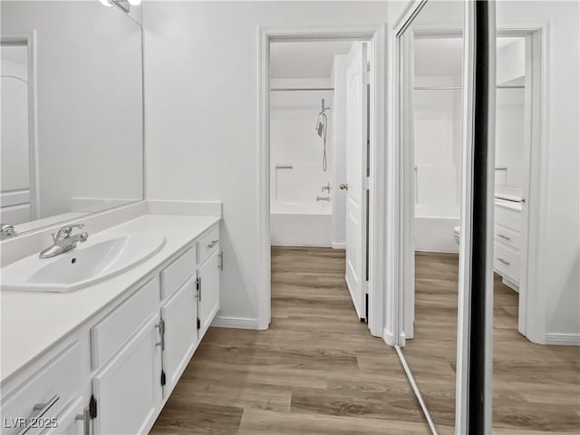 bathroom featuring vanity, hardwood / wood-style flooring, and shower / bath combination