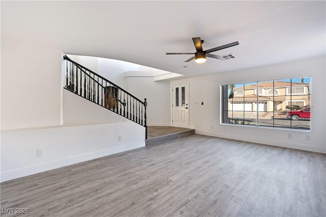 unfurnished living room featuring hardwood / wood-style floors and ceiling fan