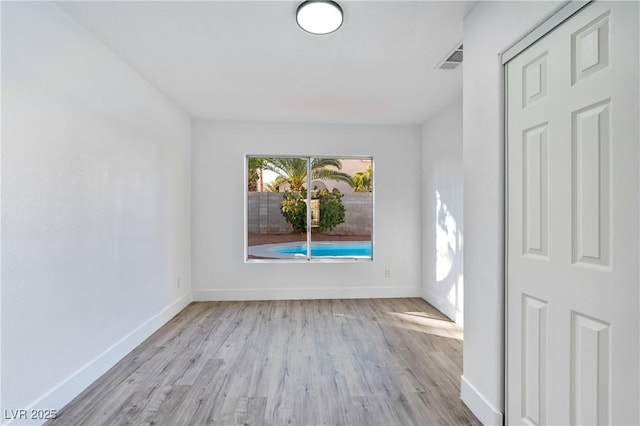 spare room featuring light wood-type flooring