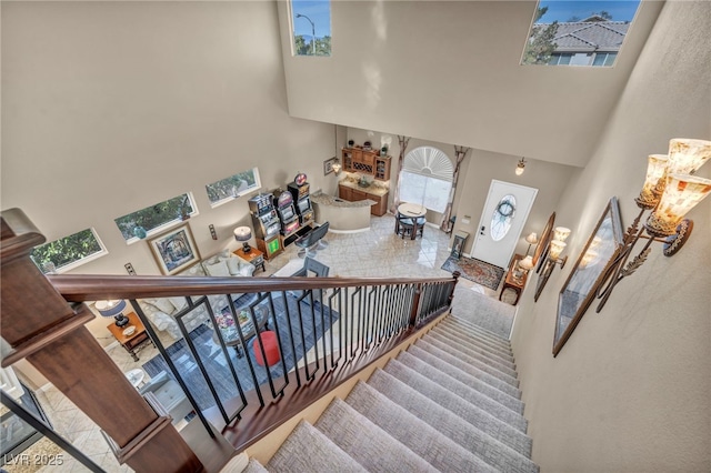 staircase featuring a towering ceiling