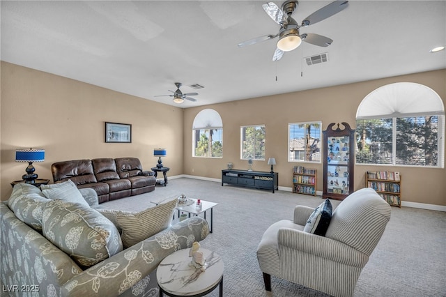 living room with ceiling fan and light colored carpet