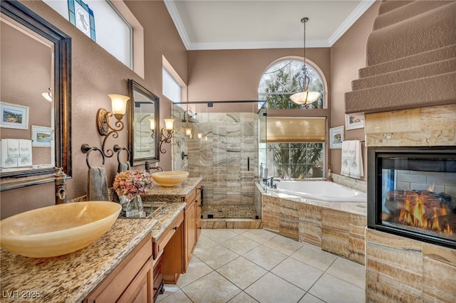 bathroom featuring a bath, a shower stall, ornamental molding, and a sink