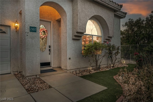 view of exterior entry at dusk