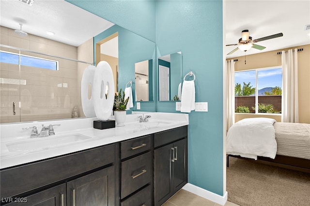 bathroom with ceiling fan, vanity, a shower with shower door, and a wealth of natural light