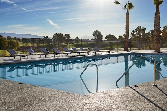 view of pool featuring a mountain view and a patio