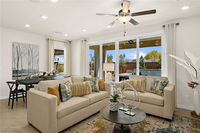 living room with ceiling fan and light tile patterned flooring