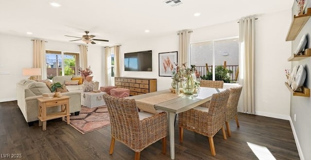 dining area with dark wood-type flooring and ceiling fan