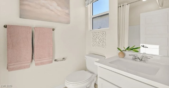 bathroom featuring vanity, toilet, and a shower with shower curtain