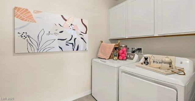 laundry room with cabinets and washer and clothes dryer