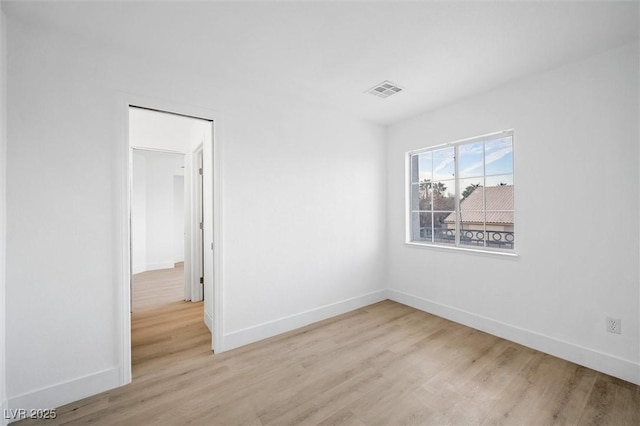 spare room with light hardwood / wood-style floors