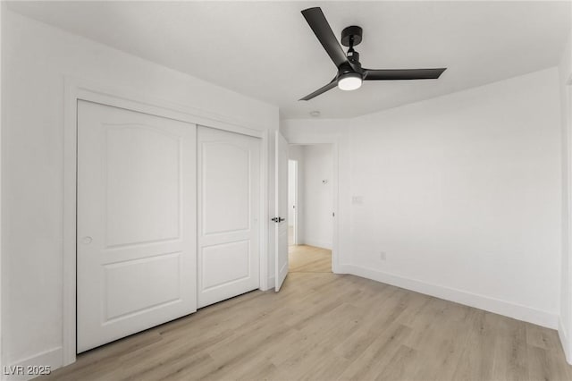 unfurnished bedroom with ceiling fan, light hardwood / wood-style floors, and a closet