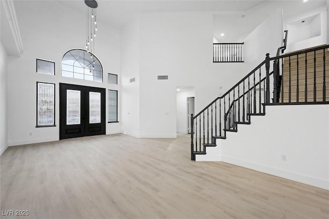 foyer featuring light hardwood / wood-style floors and french doors