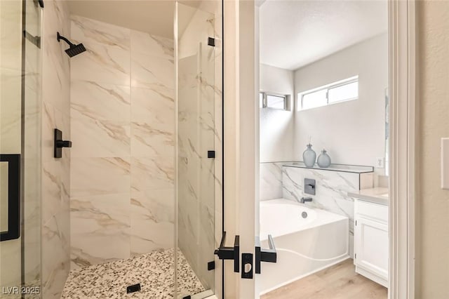 bathroom with vanity, hardwood / wood-style flooring, and independent shower and bath