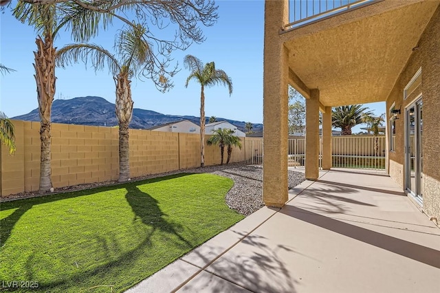 view of yard featuring a mountain view and a patio area