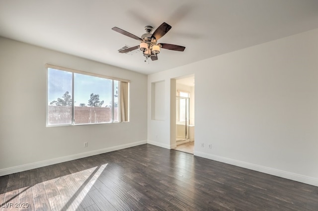 spare room with dark wood-type flooring and ceiling fan