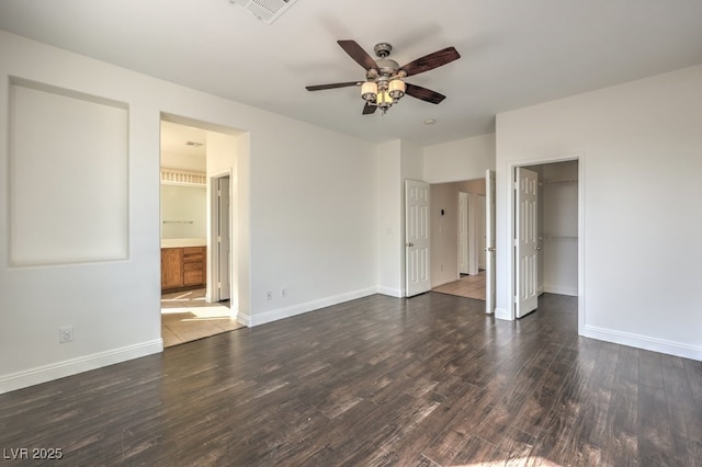 spare room featuring ceiling fan and dark hardwood / wood-style floors