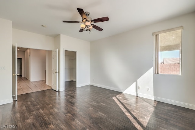 unfurnished room featuring dark hardwood / wood-style floors and ceiling fan