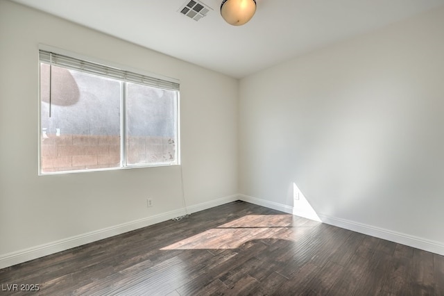 spare room with dark hardwood / wood-style floors