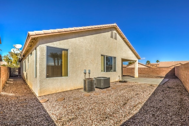 back of house featuring cooling unit and a patio area